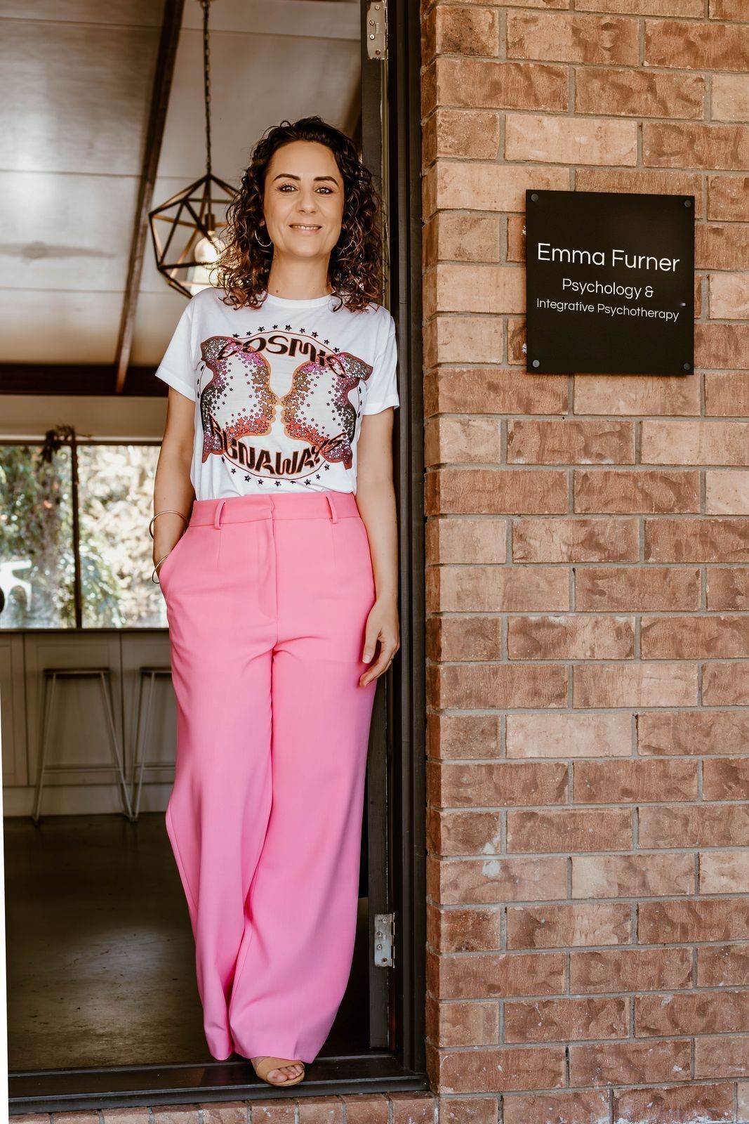 Emma standing in the doorway of her practice