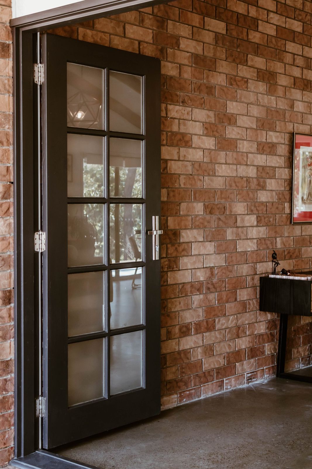 The open door into the practice, against a brick wall