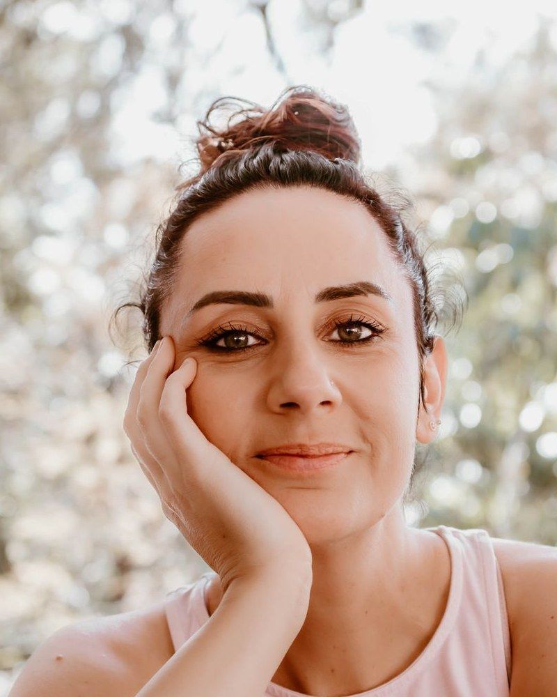 Emma Furner smiling, resting her chin on her hand