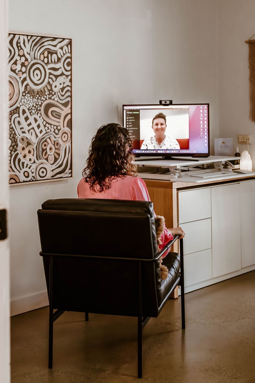 Emma in an online session at her desk